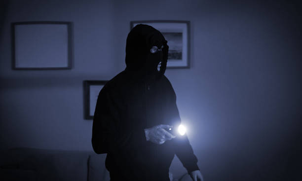 istock Thief in a balaclava at night in the house. 1470461222