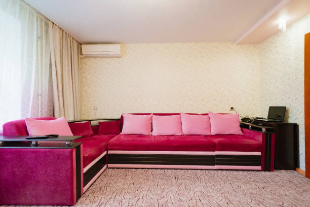 istock big pink corner sofa in interior of room. 1470461269
