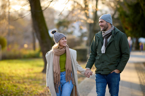 istock Romantic couple enjoying a walk in the park holding hands 1470461354