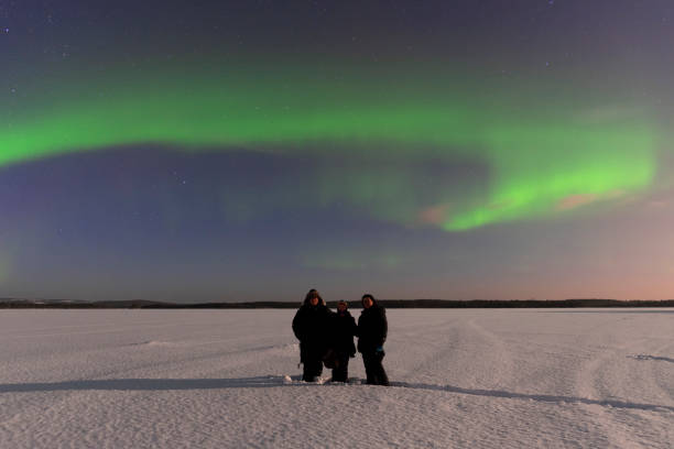 istock People watching northern lights (aurora borealis) 1470462672
