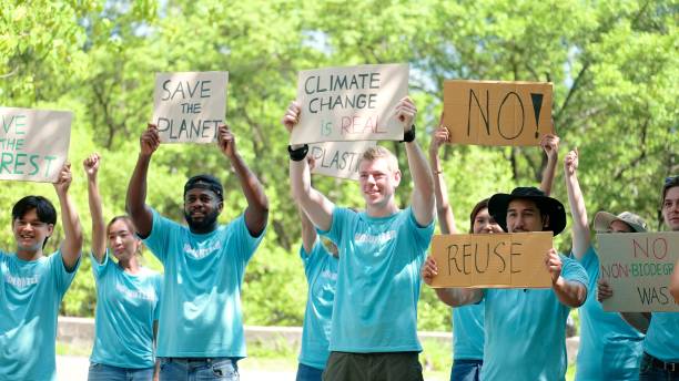 Volunteer group of people from different culture and race fight for climate change, Global warming and enviroment holding banners on environments disasters - Global warming concept Volunteer group of people from different culture and race fight for climate change, Global warming and enviroment holding banners on environments disasters - Global warming concept Volunteering Action stock pictures, royalty-free photos & images