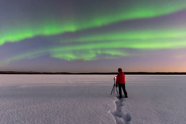istock Photographer under northern lights (aurora borealis) 1470464640