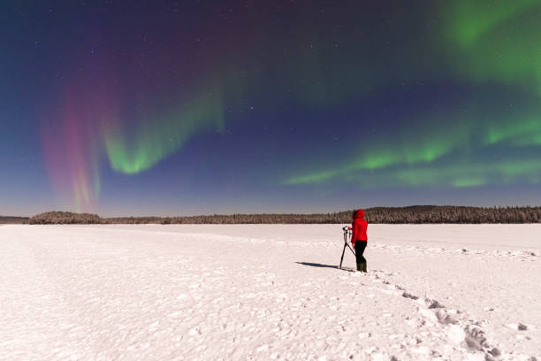 istock Person with camera and tripod under northern lights (aurora borealis) 1470464689