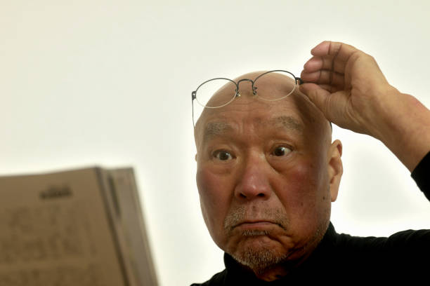 A senior man with presbyopia reads a magazine
