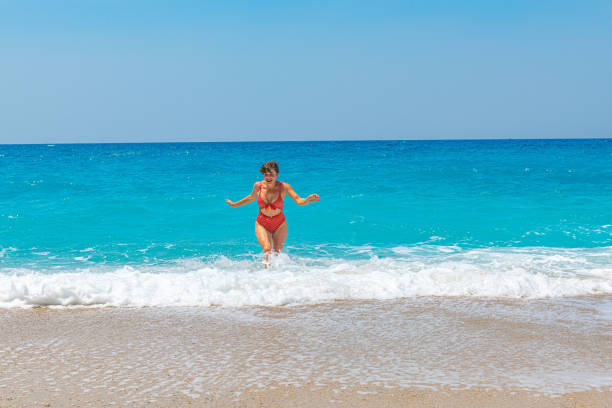 Fill each day with a little sunshine. Young woman at beach.