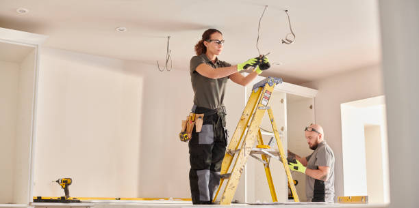female electrician working in a kitchen remodelling female electrician working in a kitchen remodelling electrician stock pictures, royalty-free photos & images
