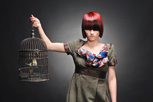 istock Beautiful young girl holding a birdcage 147046838