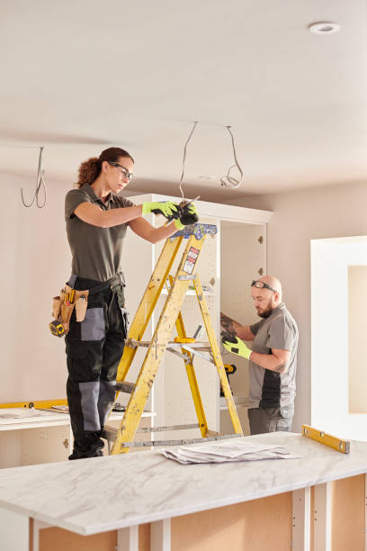 istock female electrician working in a kitchen remodelling 1470468663