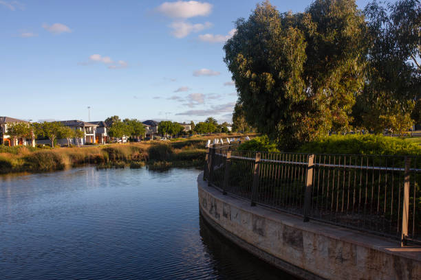 Idyllic riverside neighborhood in southampton, england, with houses reflecting in tranquil water under a clear sky