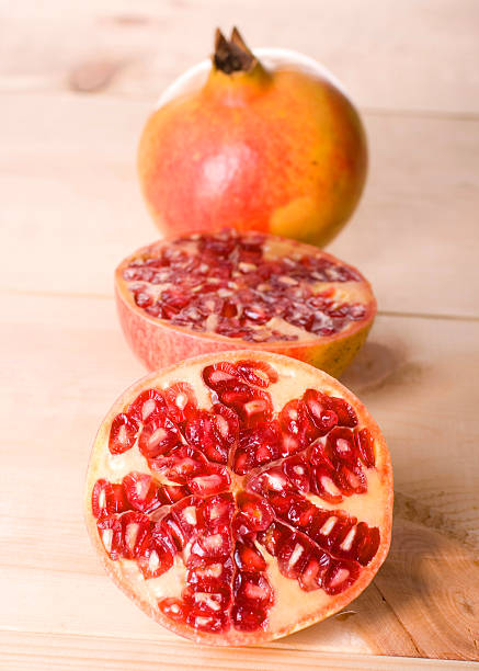 Pomegranate isolated on wood table stock photo