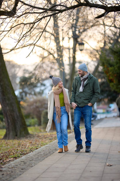 istock Romantic couple enjoying a walk in the park holding hands 1470471098