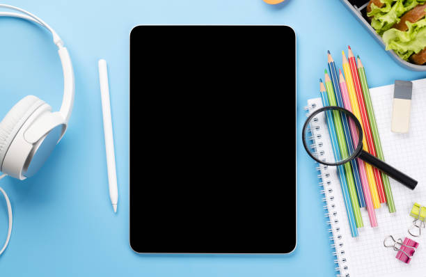 istock Tablet with blank screen, school supplies and lunch box 1470471275