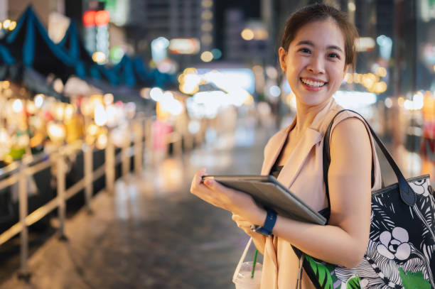 istock Young generation z asian using smartphone checking investment portfolio on mobile application outdoor 1470474554