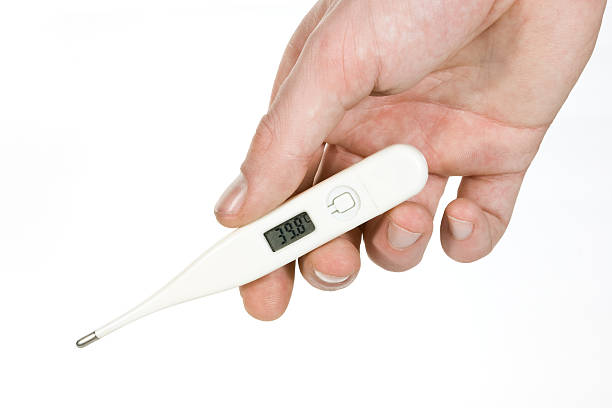 Electronic medical thermometer held in hand stock photo