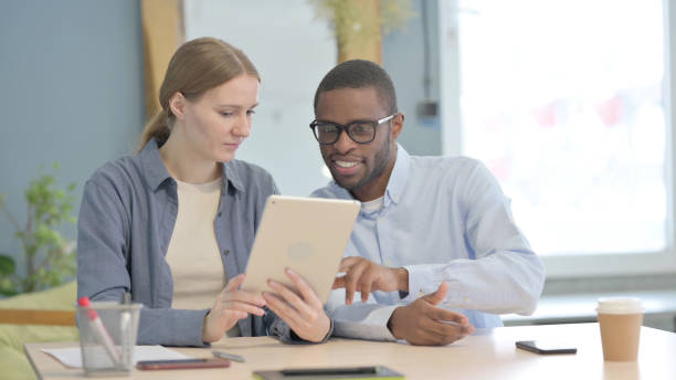 istock Multiethnic Young Business People Browsing Tablet Together 1470481223