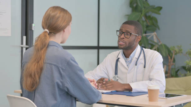 istock African Doctor Talking with Patient in Clinic 1470482759