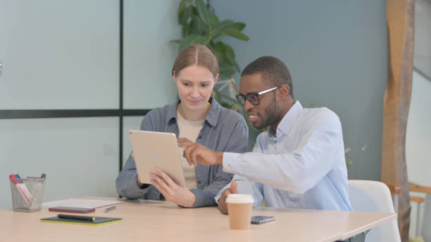 istock Multiethnic Young Business People Working on Tablet  in Office 1470484424