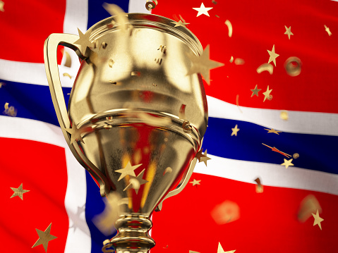 Norway Championship Concept Star Shaped Confetti Falling Onto A Gold Trophy Cup with Norwegian Flag. 3D Render