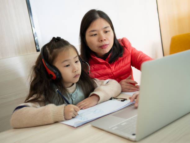 istock woman studying with her child at home 1470486352