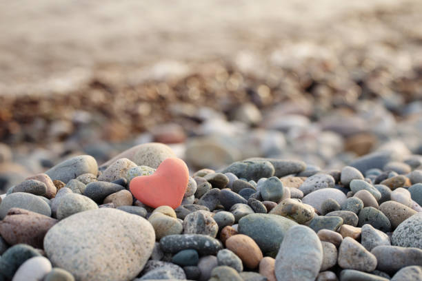 Two hearts made by stone on pink color background