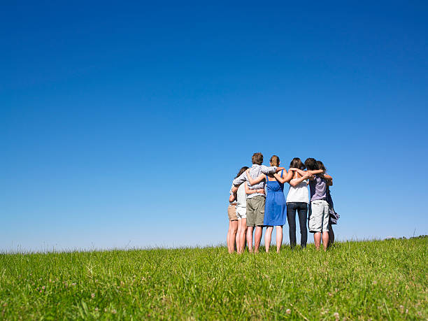 istock Group of People Huddled in Meadow 147048865