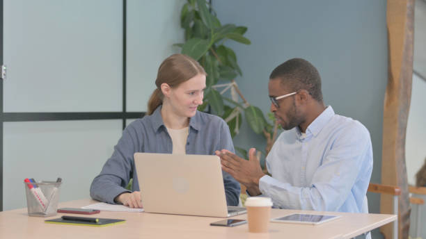 istock Mixed Race Young Business People Discussing Work, Paperwork 1470488990