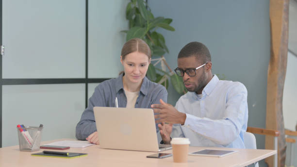 istock Young Business People Discussing Work in Office 1470489043