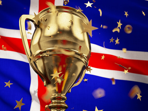 Iceland Championship Concept Star Shaped Confetti Falling Onto A Gold Trophy Cup with Icelandic Flag. 3D Render