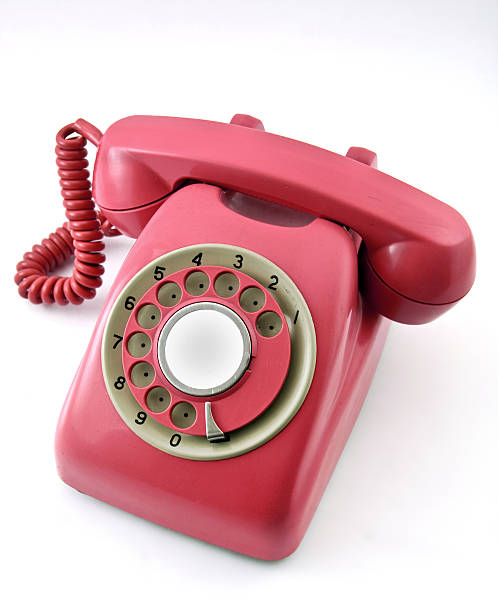 istock Magenta colored rotary telephone on a white surface  147048923