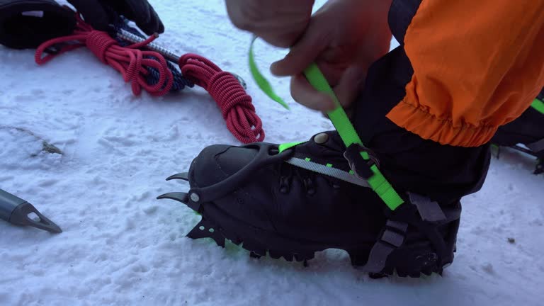 He puts mountain cats with spikes on his shoes.