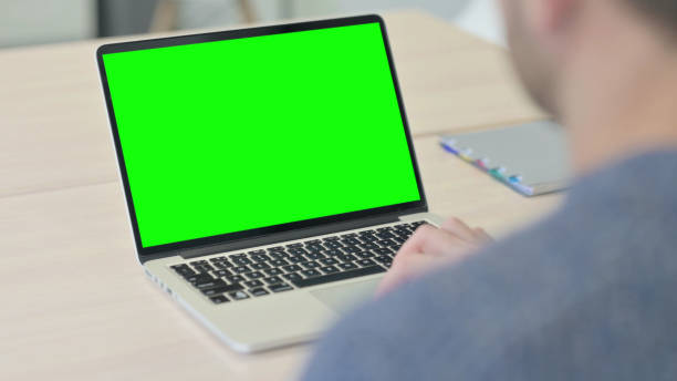 istock Man Working on Laptop with Chroma Key Green Screen 1470489489