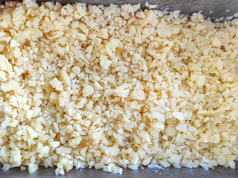 Close-up shot of crushed and chopped garlic