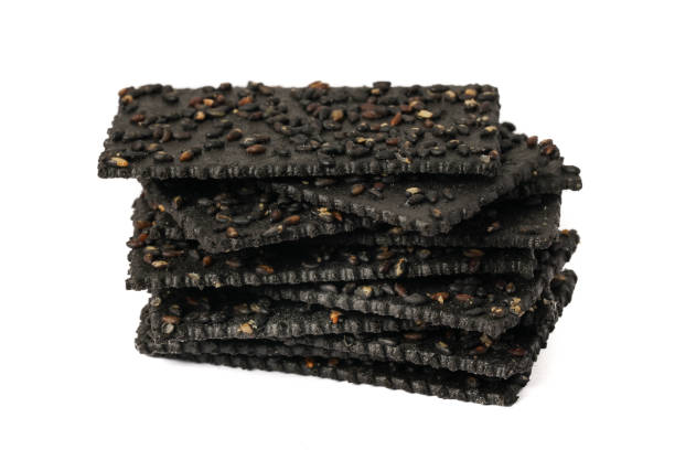 istock Crackers made of black sesame seeds on a white background 1470491488