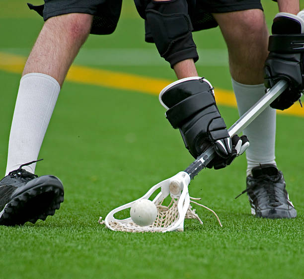 istock Boys lacrosse scooping up the ball 147049266