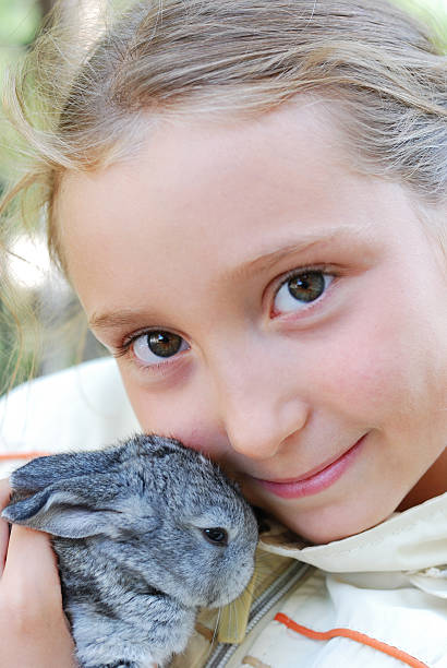 istock girl and little rabbit 147049411