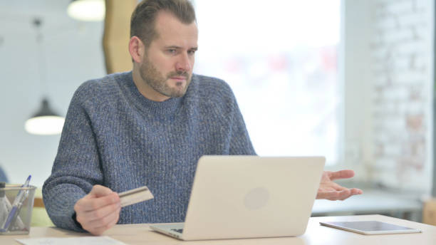 istock Middle Aged Man Unable to make Online Payment on Laptop 1470494339