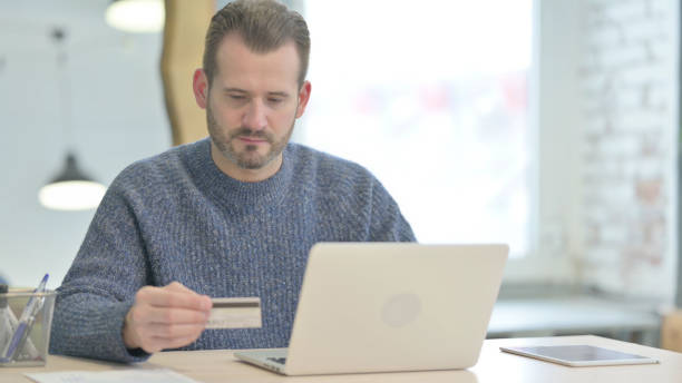 istock Middle Aged Man making Successful Online Payment on Laptop 1470494359