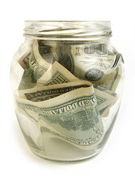 istock Dollar bills in glass jar 147049437