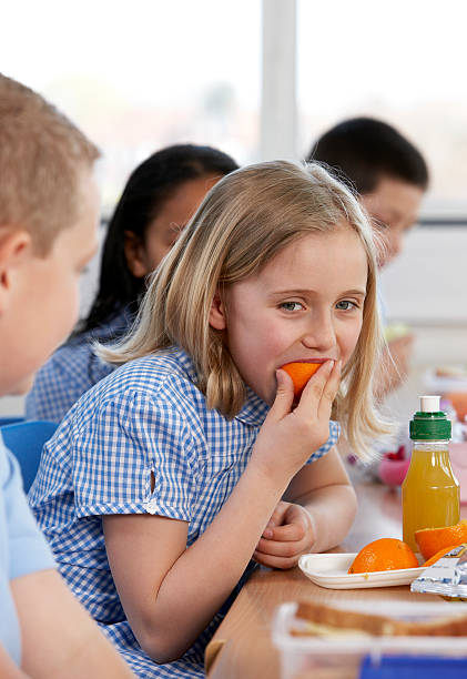 istock Young girl eating orange 147049478