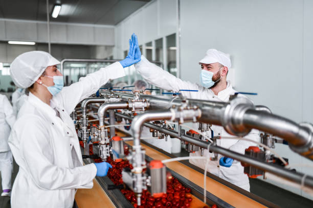 istock High Five Between Male And Female Workers In Food Processing Plant Working On Stuffed Pimenti 1470495037