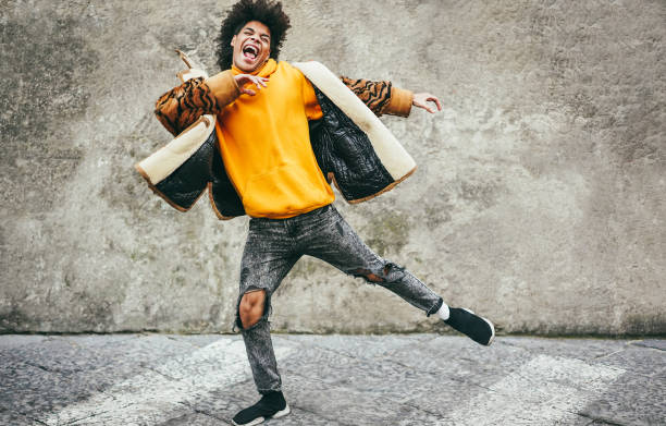 istock Young african guy having fun dancing outdoor - Soft focus on face 1470495995