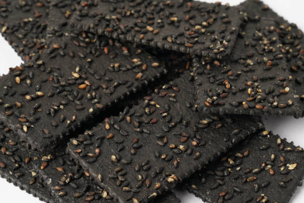 istock Crackers made of black sesame seeds on a white background 1470496615