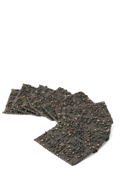 istock Crackers made of black sesame seeds on a white background 1470496869