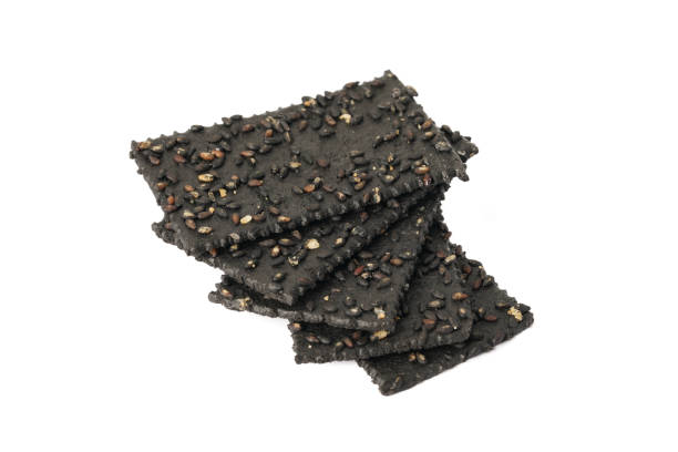 istock Crackers made of black sesame seeds on a white background 1470497641