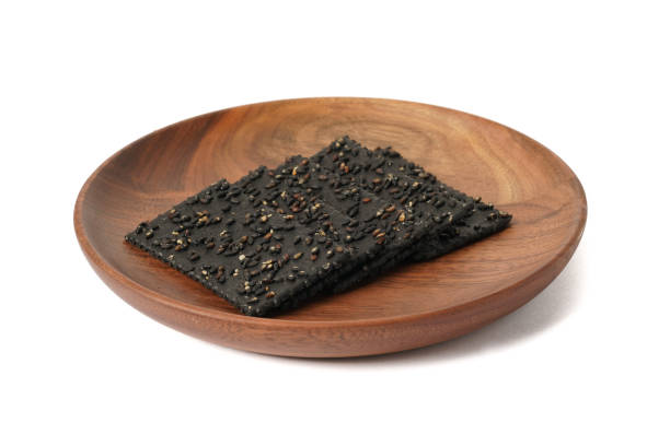 istock Crackers made of black sesame seeds on a white background 1470497767