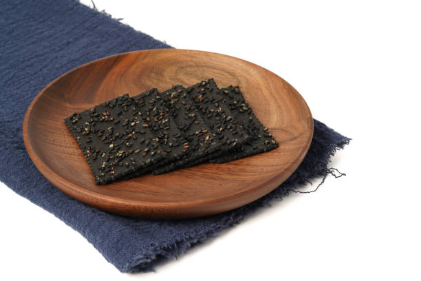 istock Crackers made of black sesame seeds on a white background 1470497892