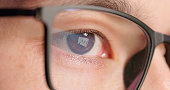 male eye closeup with eyeglasses