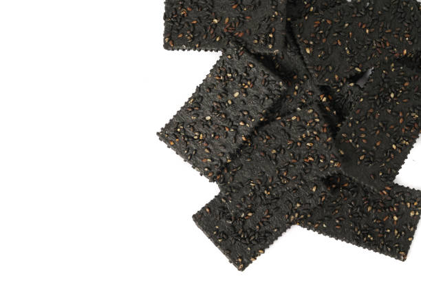 istock Crackers made of black sesame seeds on a white background 1470497994