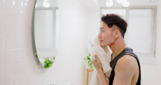 istock man wiping face with towel 1470498357