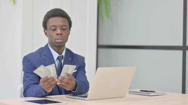 istock African Businessman Counting Dollar at Work 1470498358